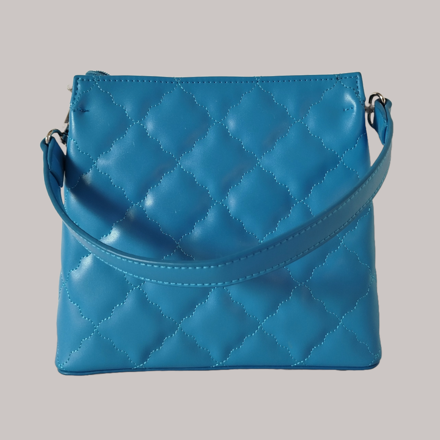 Women's blue trapezoid shaped quilted handbag with wavy diamond stitch